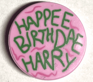 14769pb459 14769pb459 - Tile, Round 2 x 2 with Bottom Stud Holder with Green 'HAPPEE BIRTHDAE HARRY', Dark Pink Swirls Pattern